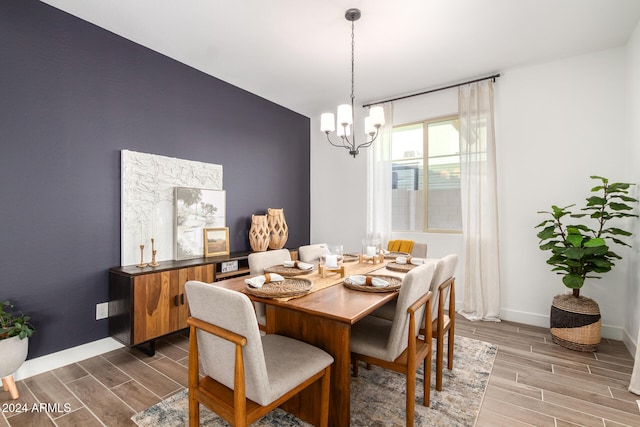 dining area featuring a chandelier and dark wood-type flooring