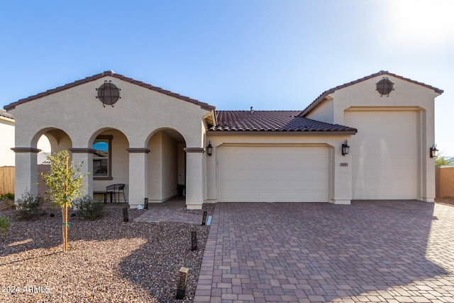 mediterranean / spanish-style home featuring a garage