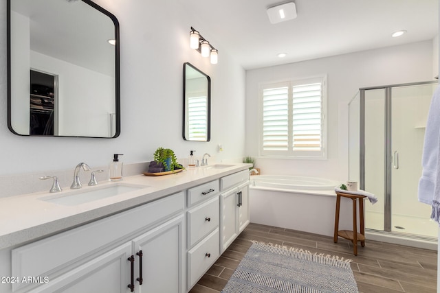 bathroom with vanity, hardwood / wood-style floors, and plus walk in shower