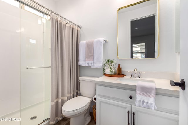 bathroom with vanity, toilet, and walk in shower