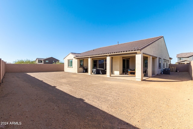 rear view of property with a patio and central AC unit