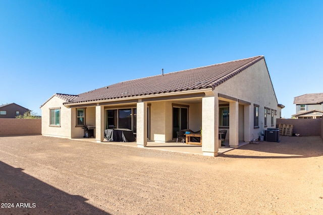 back of house with cooling unit and a patio area