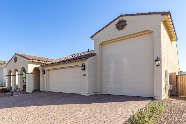 mediterranean / spanish house with a garage