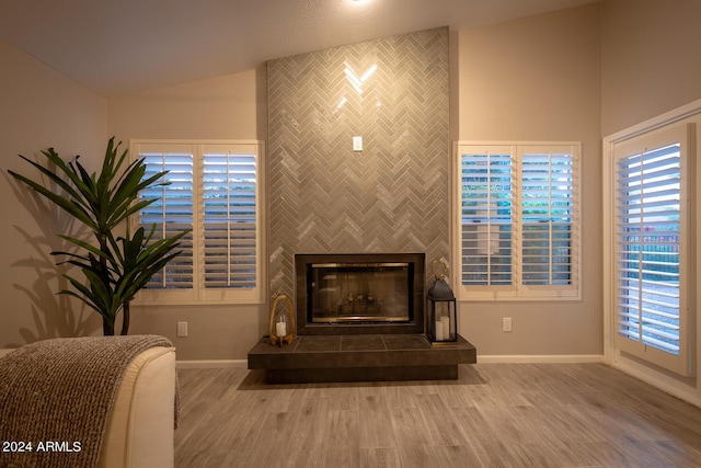 room details featuring hardwood / wood-style floors and a tiled fireplace