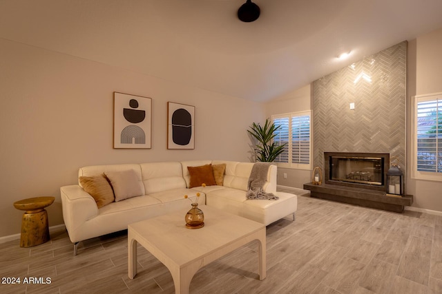 living room featuring a fireplace, hardwood / wood-style floors, and lofted ceiling