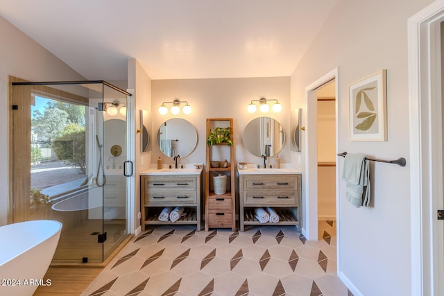 bathroom with tile patterned flooring, shower with separate bathtub, and vanity