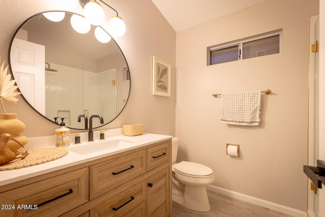 bathroom with vanity, toilet, wood-type flooring, and walk in shower