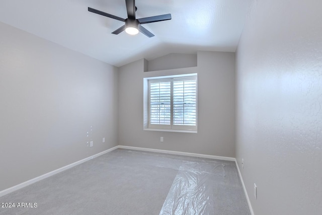 empty room featuring carpet floors, ceiling fan, and lofted ceiling