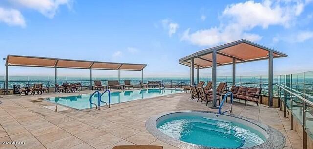 view of pool with a community hot tub and a patio