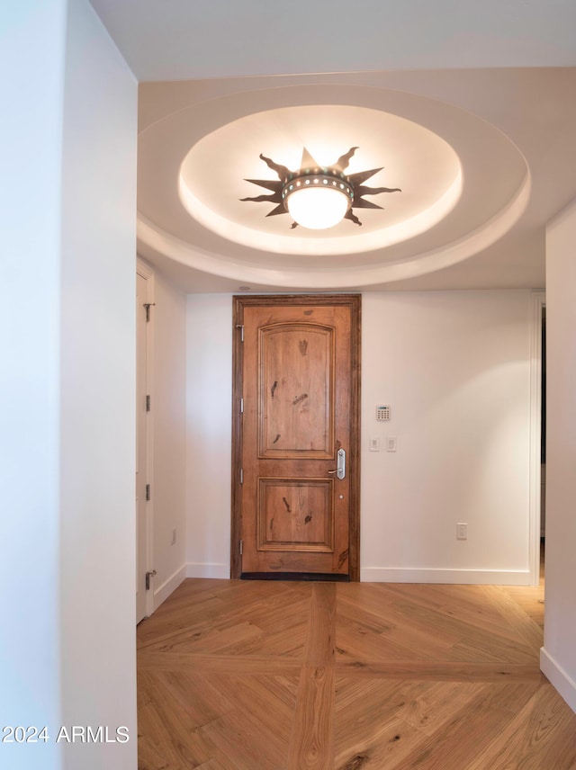 hallway with a tray ceiling