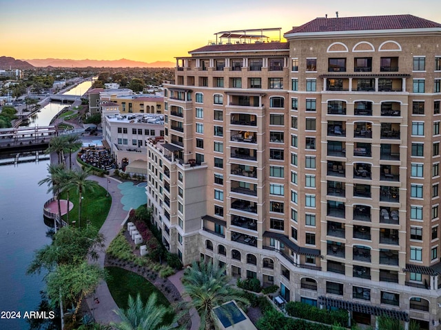 outdoor building at dusk featuring a water view