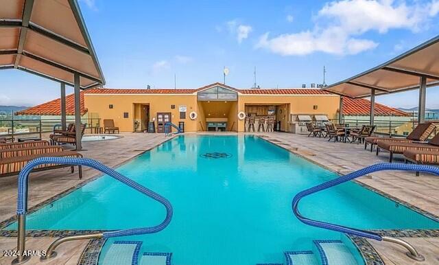 view of swimming pool featuring a patio area and a lanai