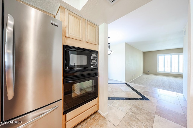 kitchen with baseboards, light brown cabinetry, open floor plan, light tile patterned floors, and black appliances