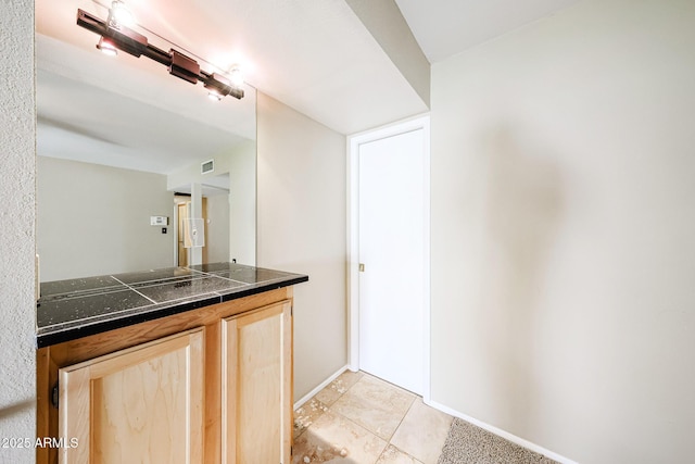 bathroom featuring tile patterned floors, visible vents, and baseboards