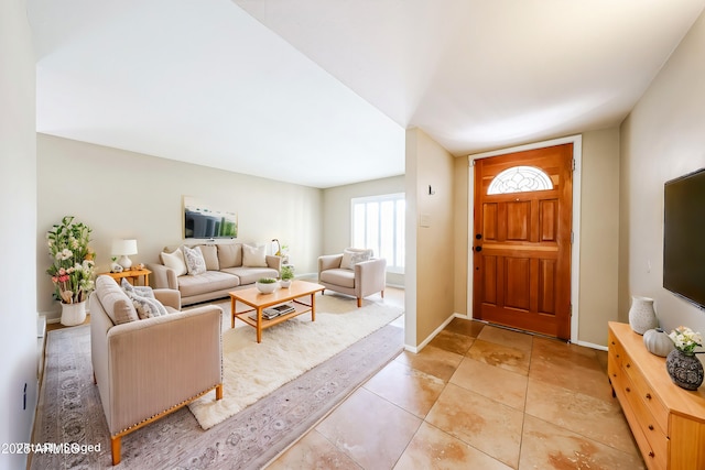 entryway featuring light tile patterned floors and baseboards