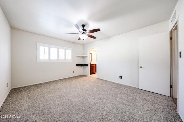 unfurnished bedroom featuring visible vents, baseboards, carpet, ensuite bathroom, and a ceiling fan