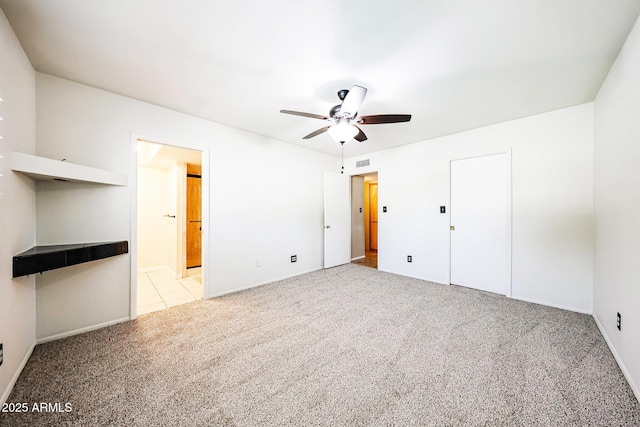 unfurnished bedroom with visible vents, carpet floors, connected bathroom, and a ceiling fan