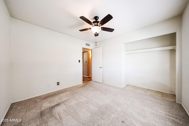 unfurnished bedroom with visible vents, a ceiling fan, and carpet floors