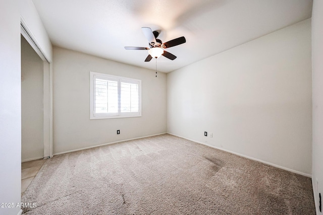 spare room with carpet and ceiling fan