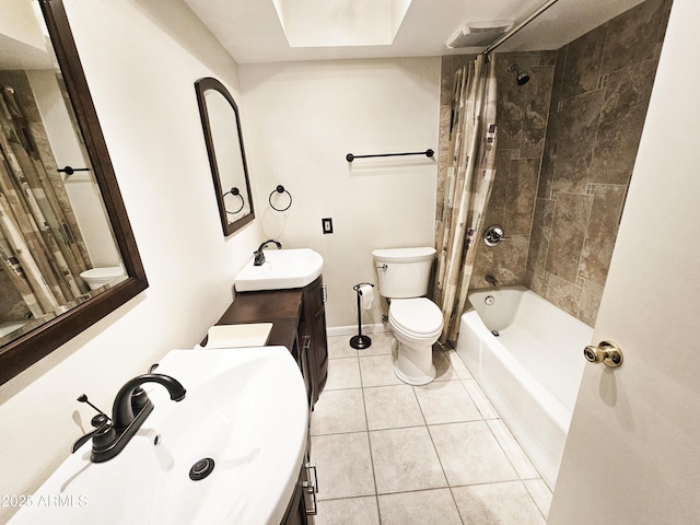 bathroom with a sink, toilet, shower / bath combo, and tile patterned floors