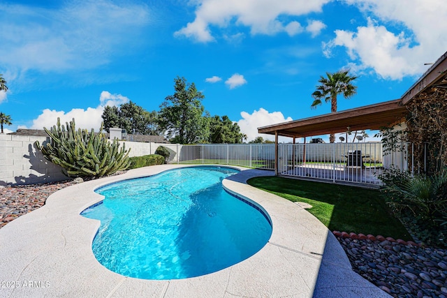 view of swimming pool with a fenced in pool, a lawn, and a fenced backyard