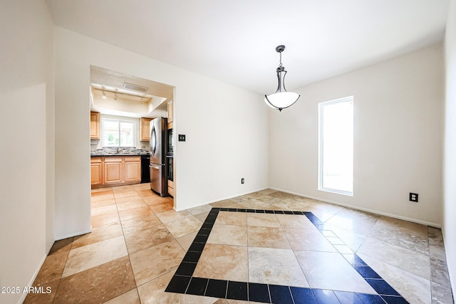 unfurnished room featuring visible vents and baseboards