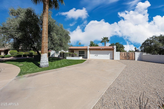 ranch-style home with driveway, a tile roof, a front lawn, a gate, and a garage