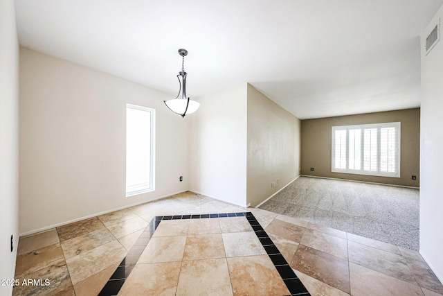 empty room with visible vents, carpet flooring, and baseboards