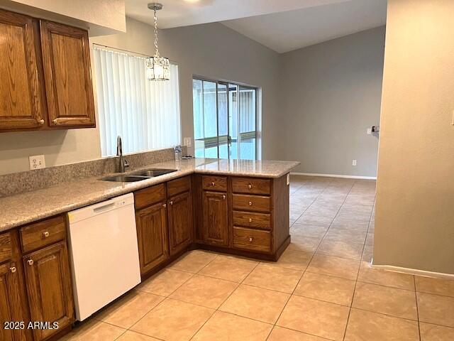 kitchen with sink, dishwasher, kitchen peninsula, and light tile patterned floors