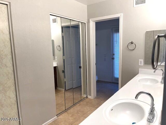 bathroom with vanity and tile patterned flooring