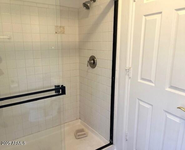 bathroom with a shower with door