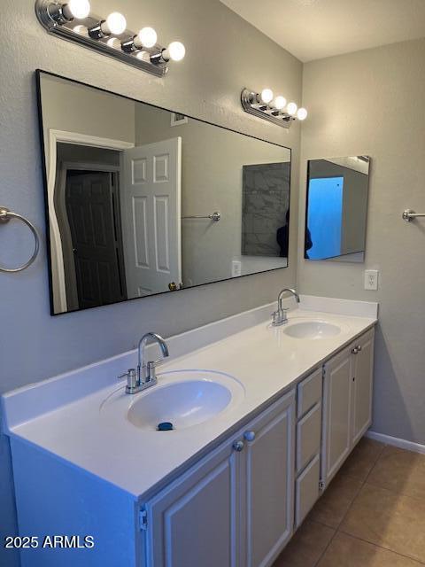 bathroom with tile patterned flooring and vanity