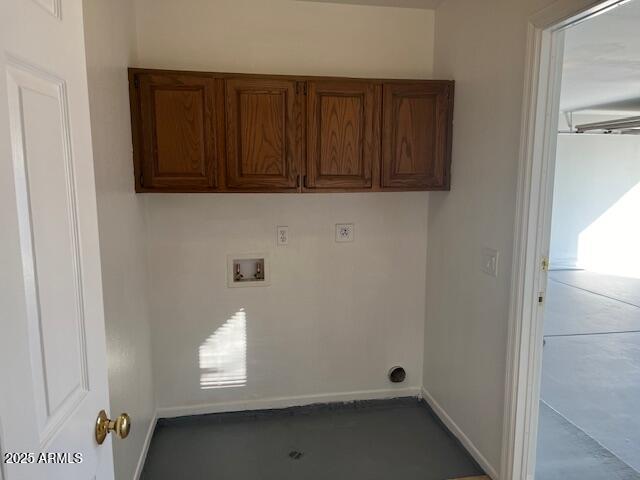 clothes washing area featuring washer hookup and cabinets