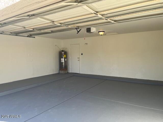 garage featuring a garage door opener and electric water heater