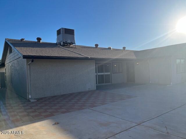 rear view of property featuring a patio area and cooling unit