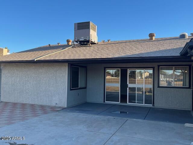 back of house with a patio area and central AC