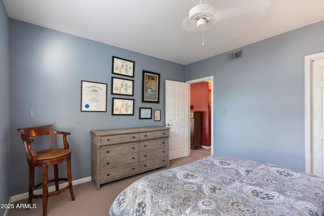carpeted bedroom featuring a ceiling fan, baseboards, and visible vents