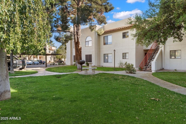 surrounding community featuring stairway and a yard