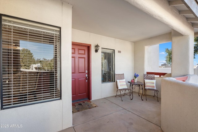 entrance to property featuring stucco siding