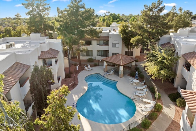pool featuring a patio, a gazebo, and a residential view