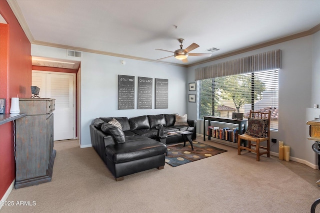 carpeted living area with baseboards, visible vents, ceiling fan, and ornamental molding