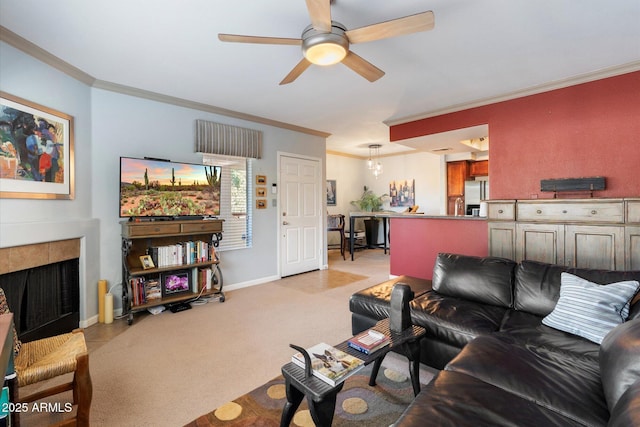 living room featuring ornamental molding, light carpet, a tiled fireplace, and ceiling fan
