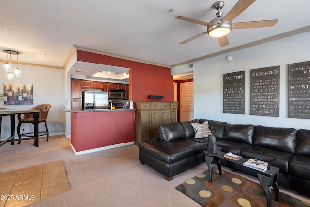 living room featuring light colored carpet, crown molding, ceiling fan, and baseboards