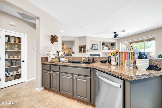 kitchen with tile counters, gray cabinets, visible vents, stainless steel dishwasher, and a sink
