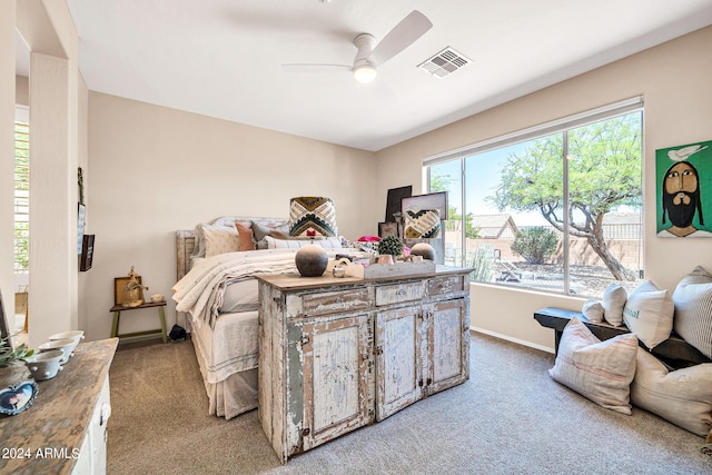 carpeted bedroom with a ceiling fan, visible vents, and baseboards