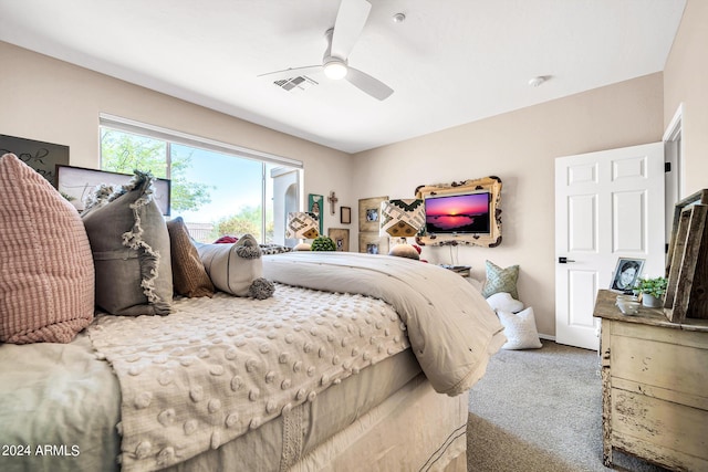 carpeted bedroom featuring ceiling fan and visible vents