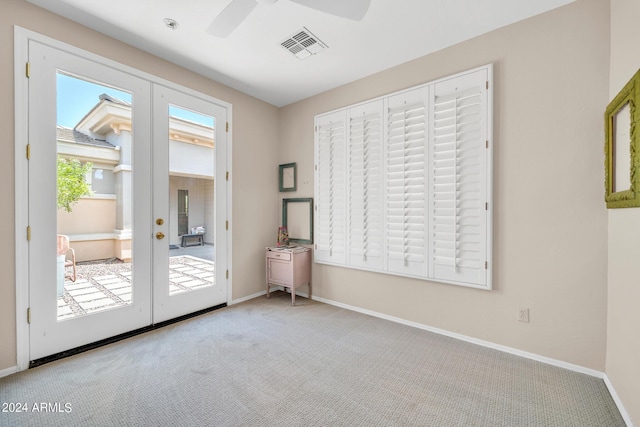unfurnished room featuring carpet floors, french doors, visible vents, and baseboards