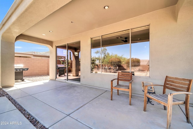 view of patio / terrace featuring a grill and fence