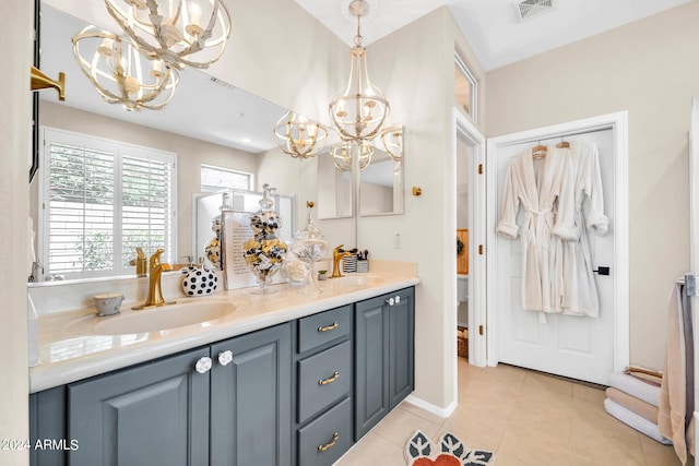 full bath featuring tile patterned flooring, a sink, visible vents, double vanity, and an inviting chandelier