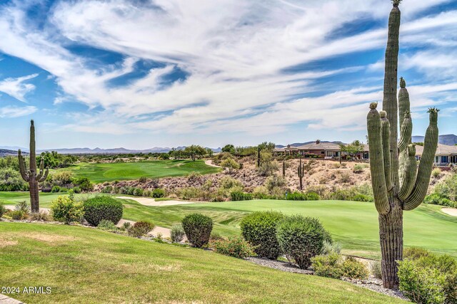 view of property's community with a yard and golf course view